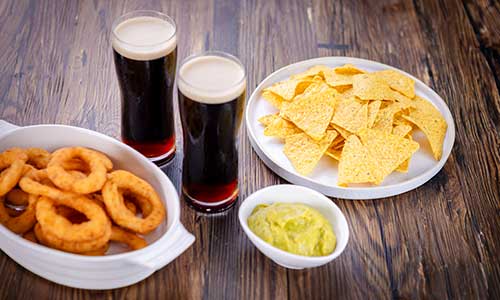 onion rings, chips and beer in a pub